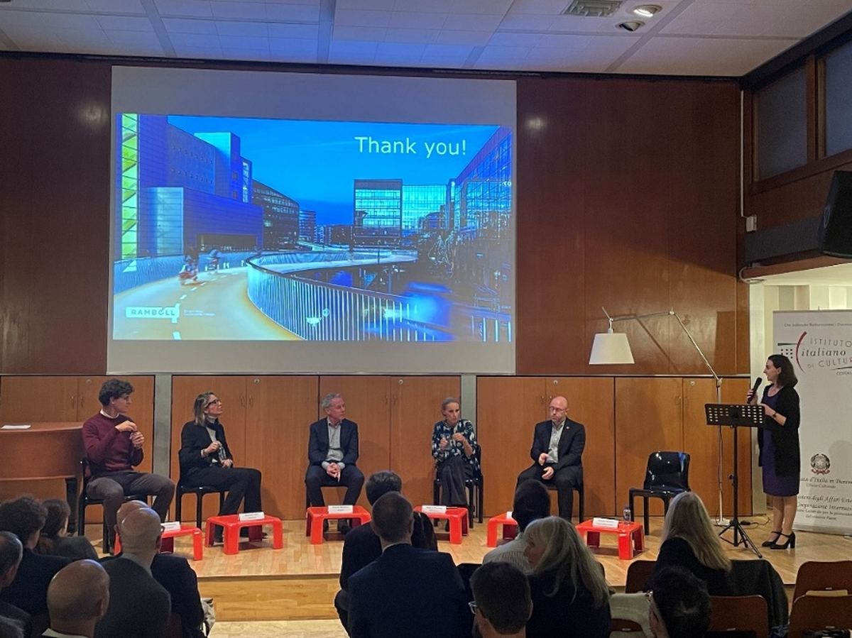 Speakers seated on the stage of the Italian Institute of Culture